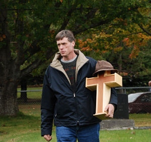 Mike Holm carrying his father's urn into the cemetery