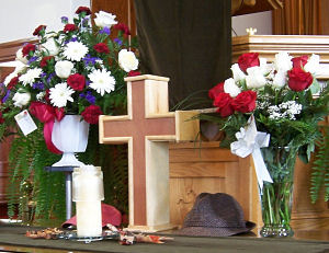 The cross-shaped urn in the church for the funeral service